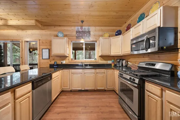 a kitchen with granite countertop a stove sink and cabinets