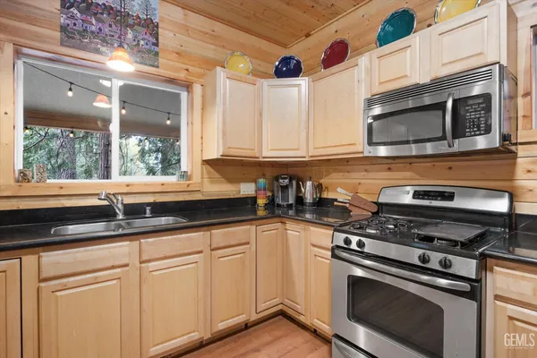 a kitchen with granite countertop a sink and a window