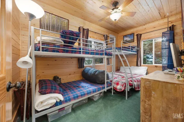 a bedroom with bunk bed and a window