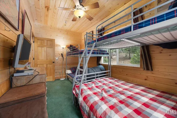 a bedroom with two beds and a chandelier