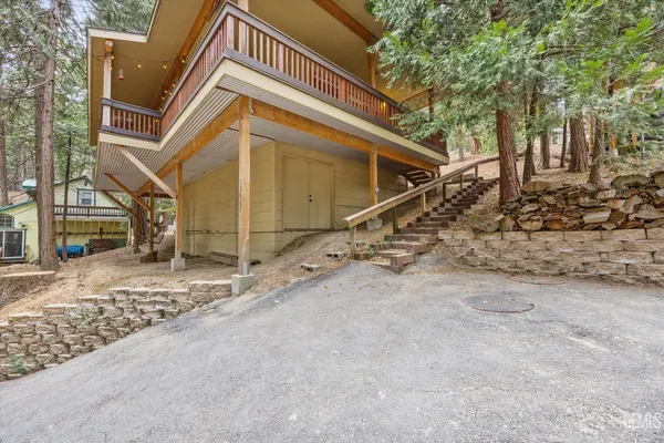 a backyard of a house with barbeque oven and door