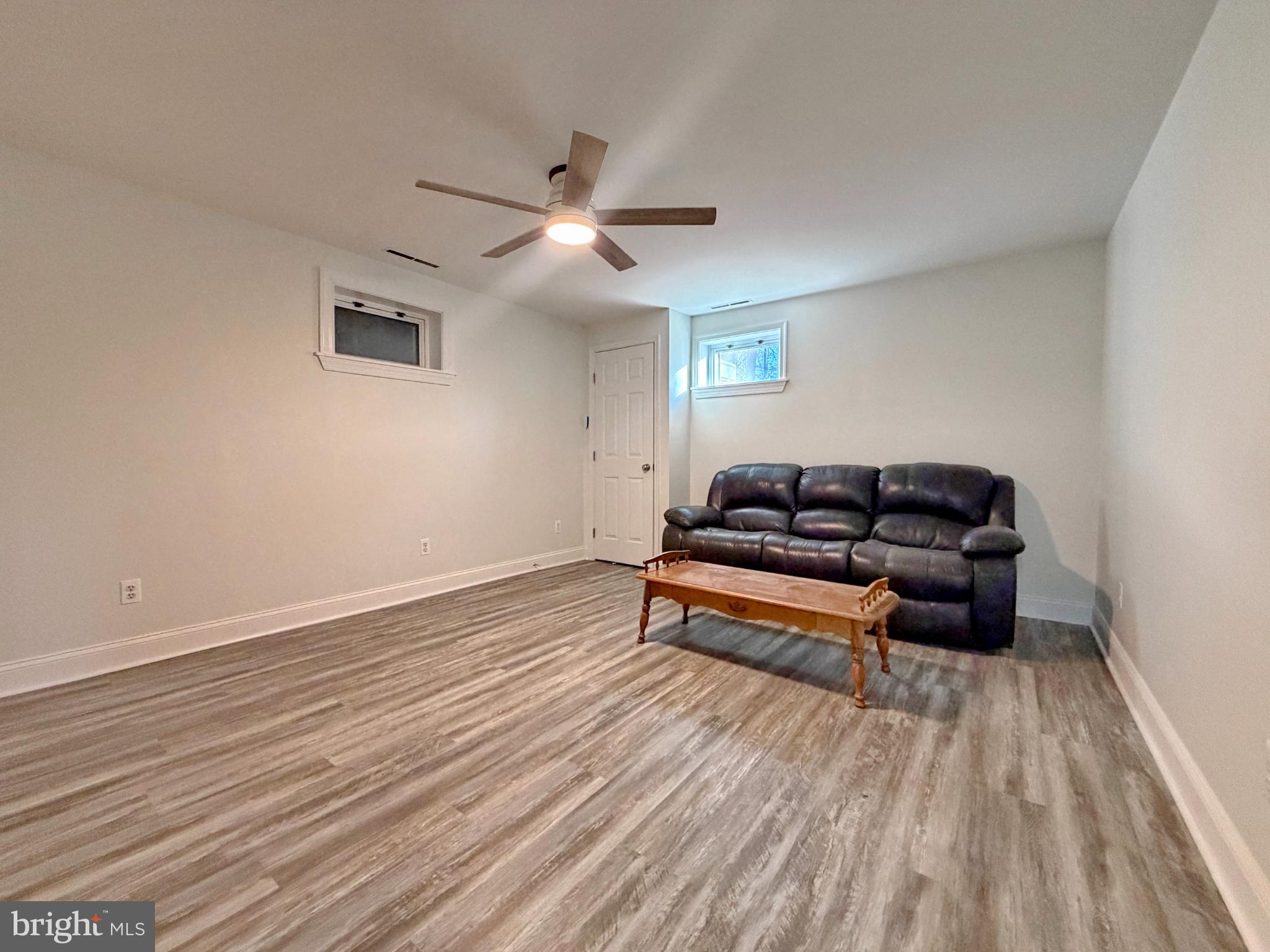 9350 Mathir Drive La Plata, MD 20646 - Photo 18 of 44 a view of a room with wooden floor and ceiling fan