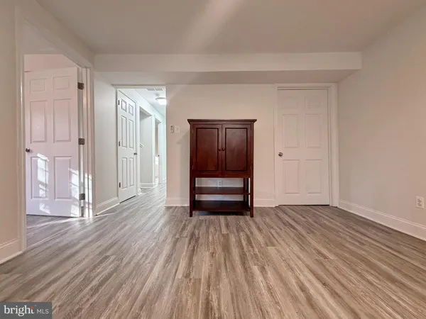 a view of an empty room and wooden floor