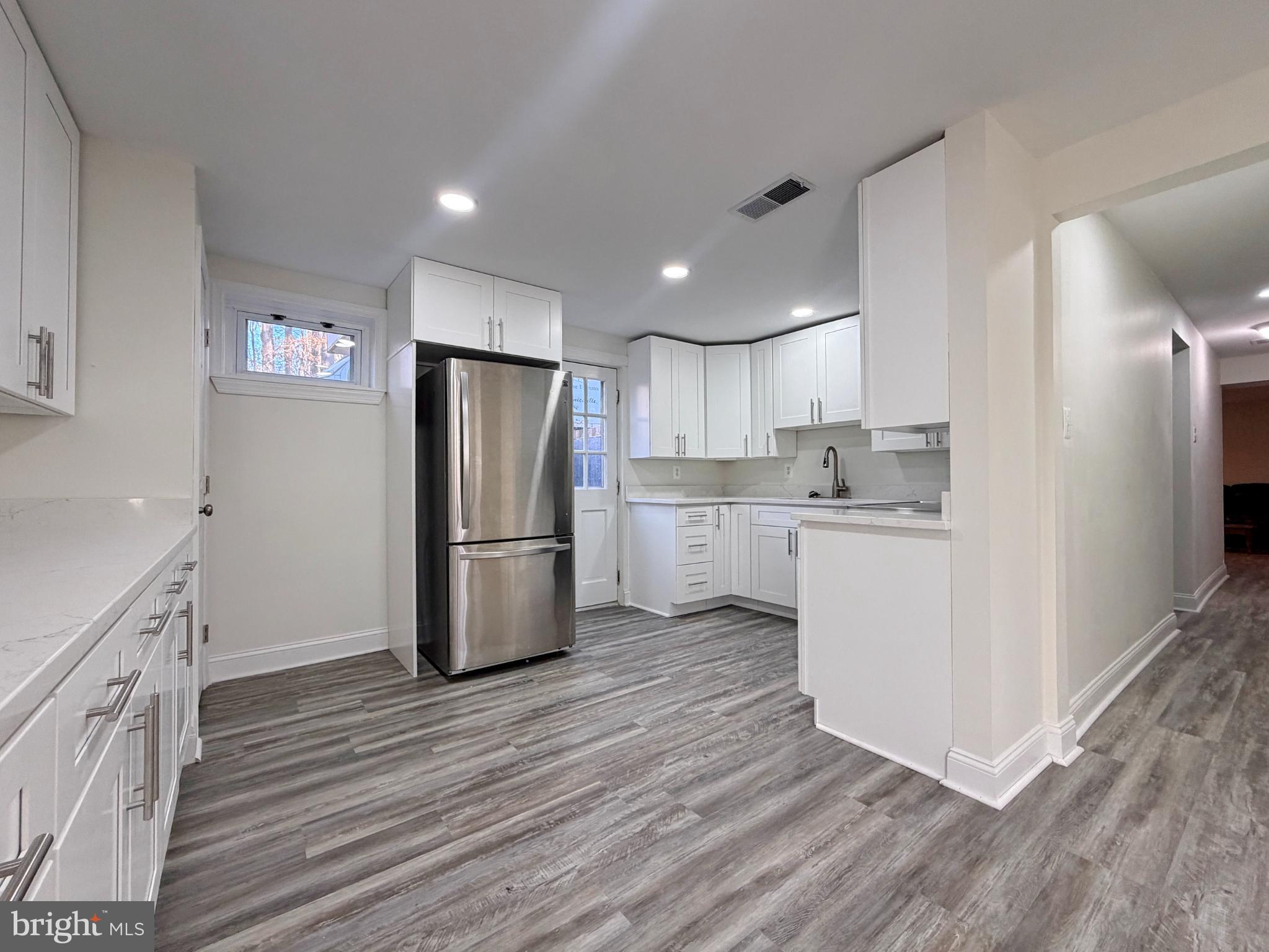 9350 Mathir Drive La Plata, MD 20646 - Photo 29 of 44 a kitchen with a refrigerator a sink and cabinets