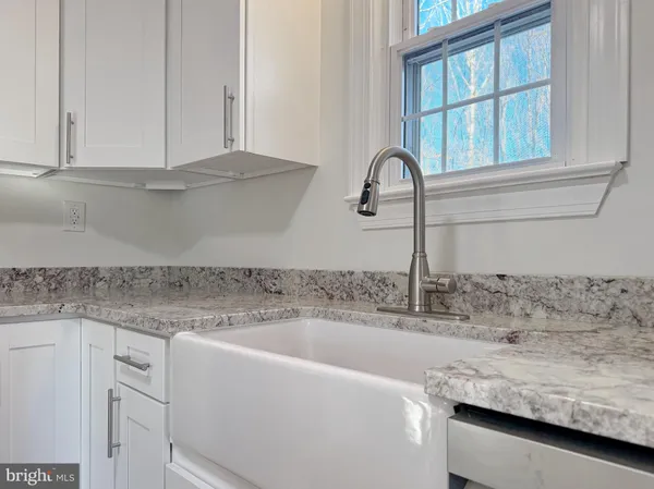 a kitchen with granite countertop a sink and a window