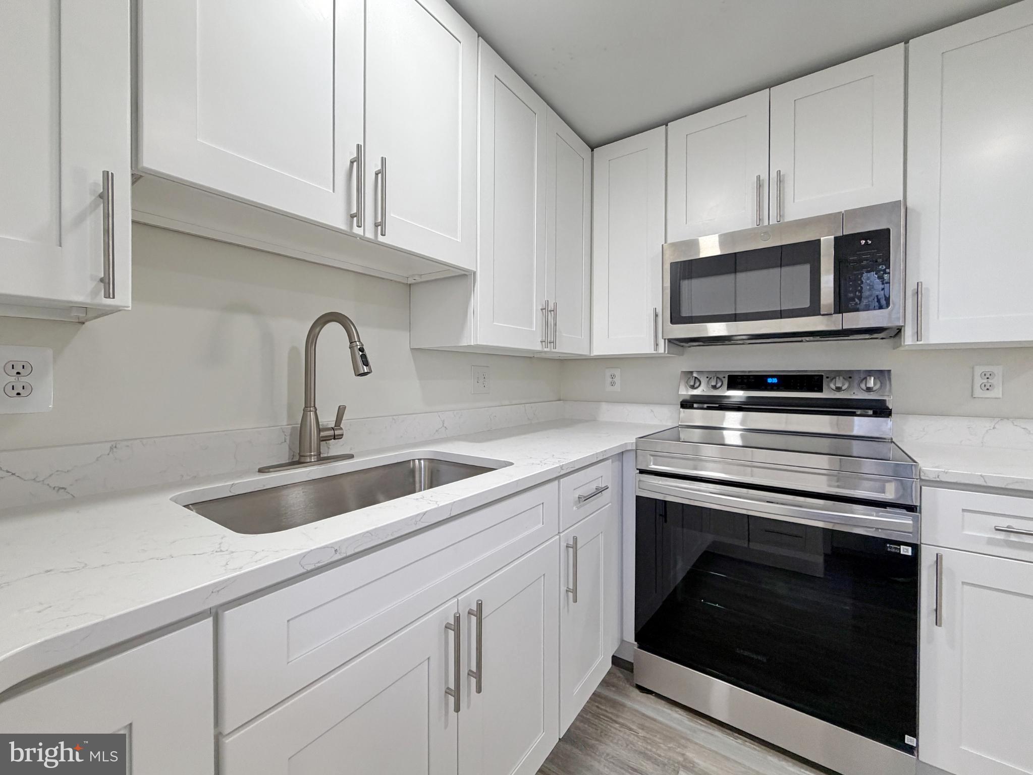 9350 Mathir Drive La Plata, MD 20646 - Photo 31 of 44 a kitchen with granite countertop a stove sink and cabinets