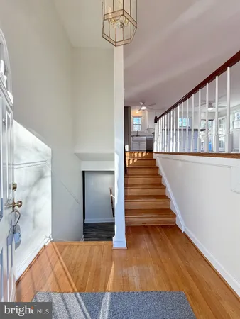 a view of entryway and hall with wooden floor