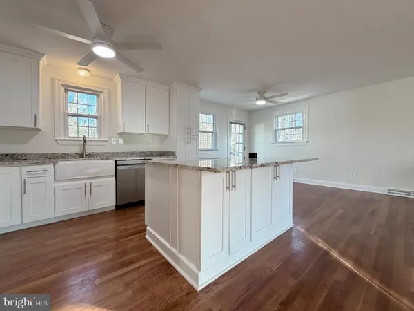 a kitchen with stainless steel appliances granite countertop a stove a sink dishwasher and a refrigerator