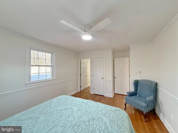 a bedroom with a bed and chair