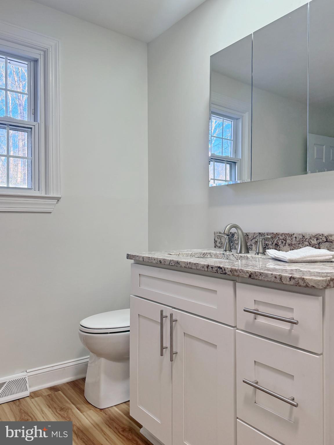 9350 Mathir Drive La Plata, MD 20646 - Photo 10 of 44 a bathroom with a granite countertop toilet sink and mirror