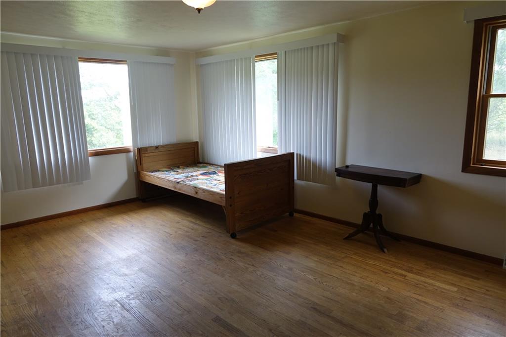 917 New Castle Road Butler, PA 16001 - Photo 13 of 25 Bedroom with hardwood flooring