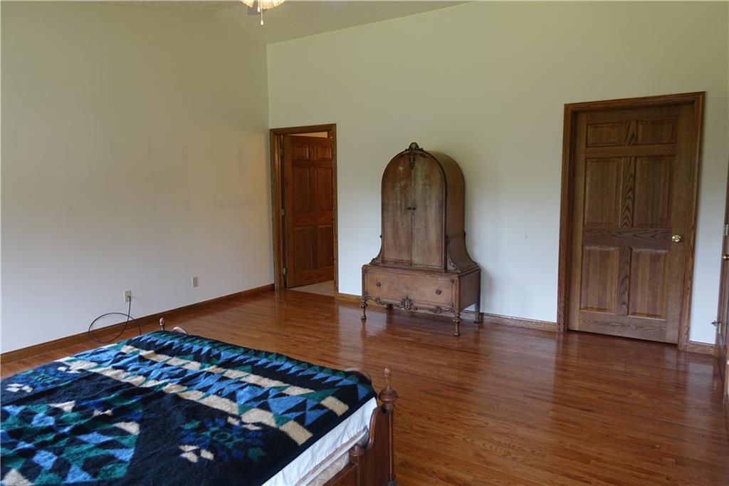 917 New Castle Road Butler, PA 16001 - Photo 10 of 25 Master Bedroom with hardwood flooring, large master bathroom and walk-in closet