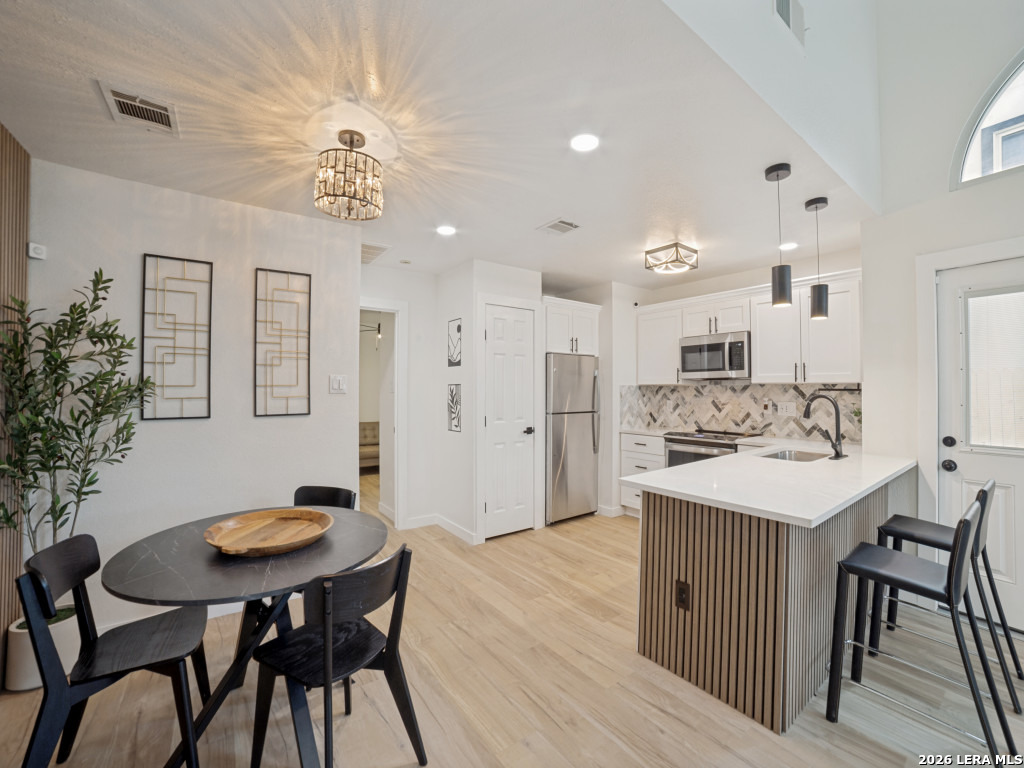 3439 Ridge Ranch San Antonio, TX 78247 - Photo 8 of 25 a kitchen with stainless steel appliances kitchen island a table and chairs in it