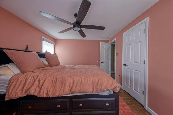 a bedroom with a bed and a ceiling fan