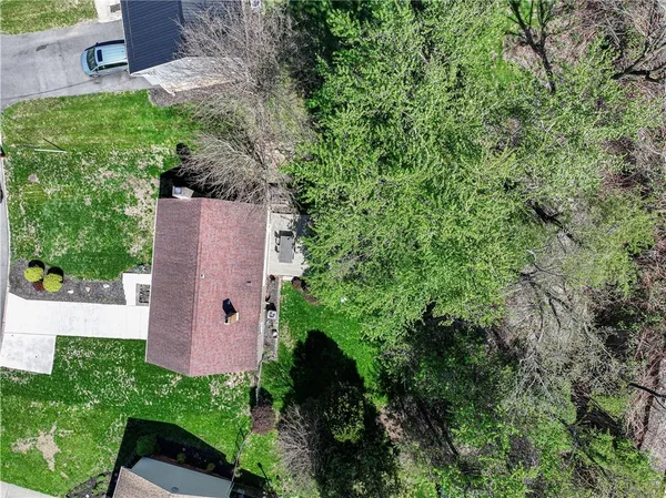 an aerial view of a house with yard and outdoor seating