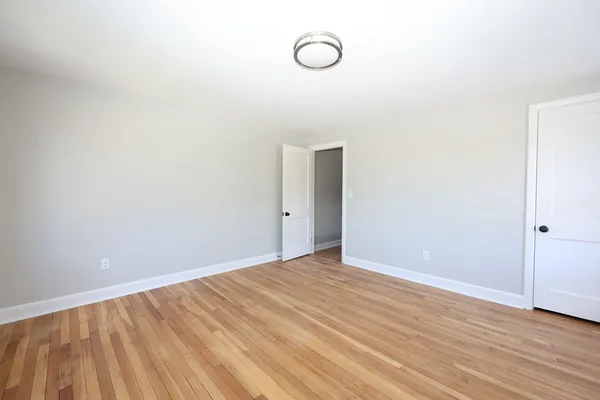 a view of room with wooden floor