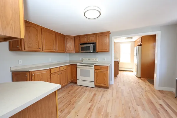 a kitchen with granite countertop wooden floors and stainless steel appliances