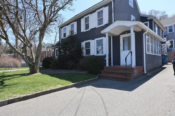 a front view of a house with garden