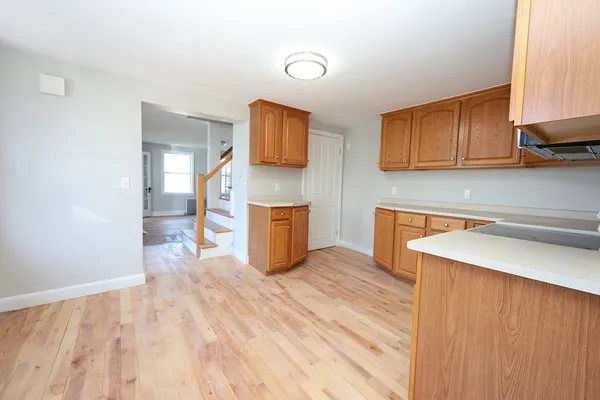 a view of kitchen with sink and wooden floor