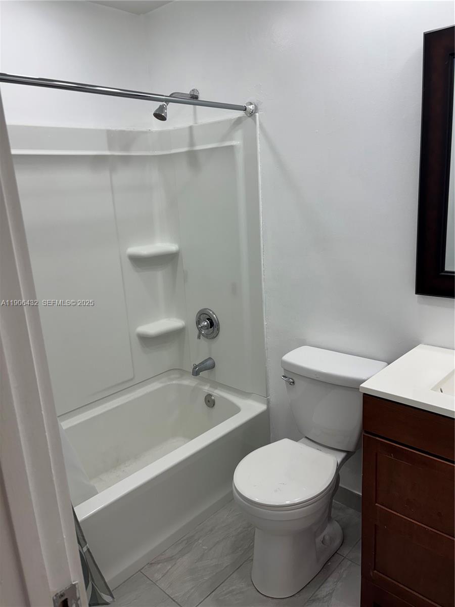 4314 Southwest 148th Court Miami, FL 33185 - Photo 20 of 32 a bathroom with a toilet and a bathtub