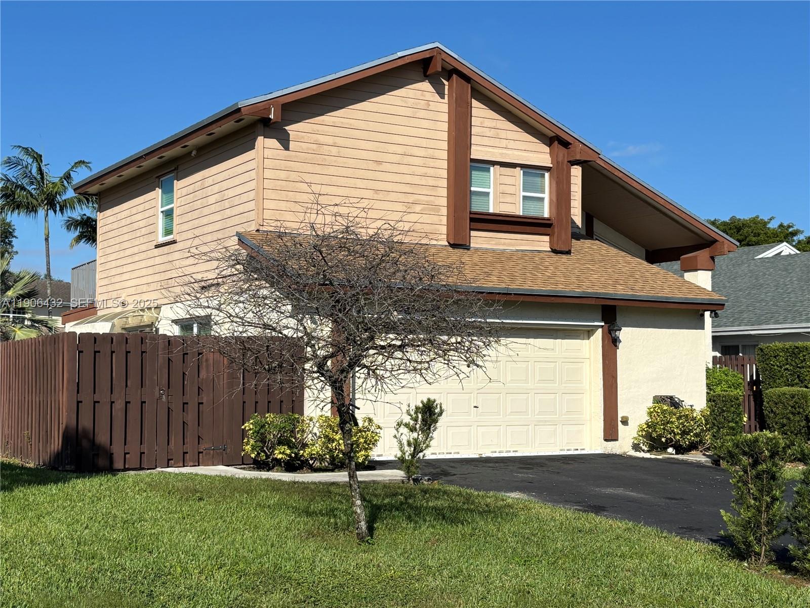4314 Southwest 148th Court Miami, FL 33185 - Photo 2 of 32 a backyard of a house with table and chairs