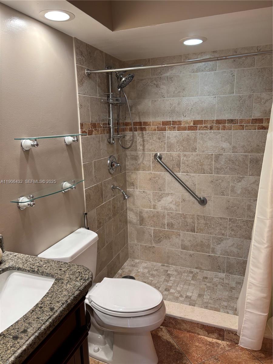 4314 Southwest 148th Court Miami, FL 33185 - Photo 21 of 32 a bathroom with a granite countertop toilet a sink and shower