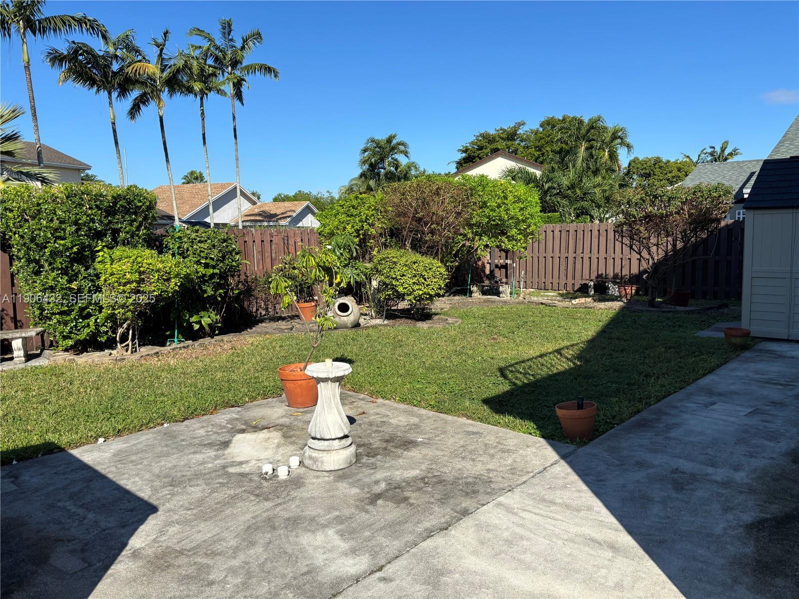 4314 Southwest 148th Court Miami, FL 33185 - Photo 27 of 32 a view of a backyard with a garden and plants
