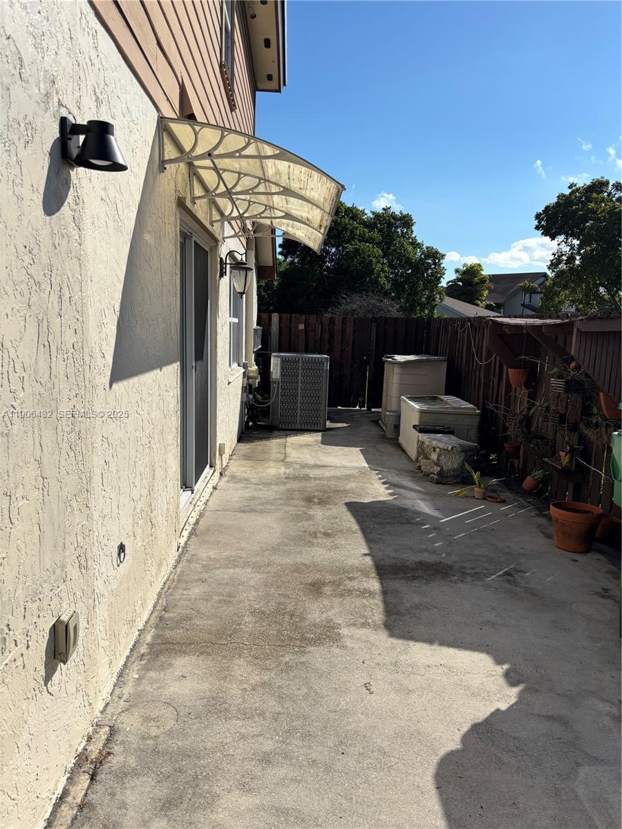 4314 Southwest 148th Court Miami, FL 33185 - Photo 30 of 32 a view of a patio with table and chairs with wooden fence