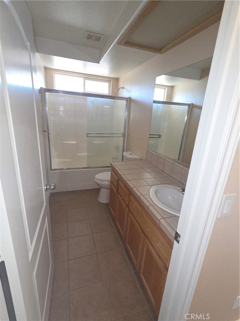10141 Rochester Road Phelan, CA 92371 - Photo 12 of 22 a bathroom with a granite countertop sink toilet and shower
