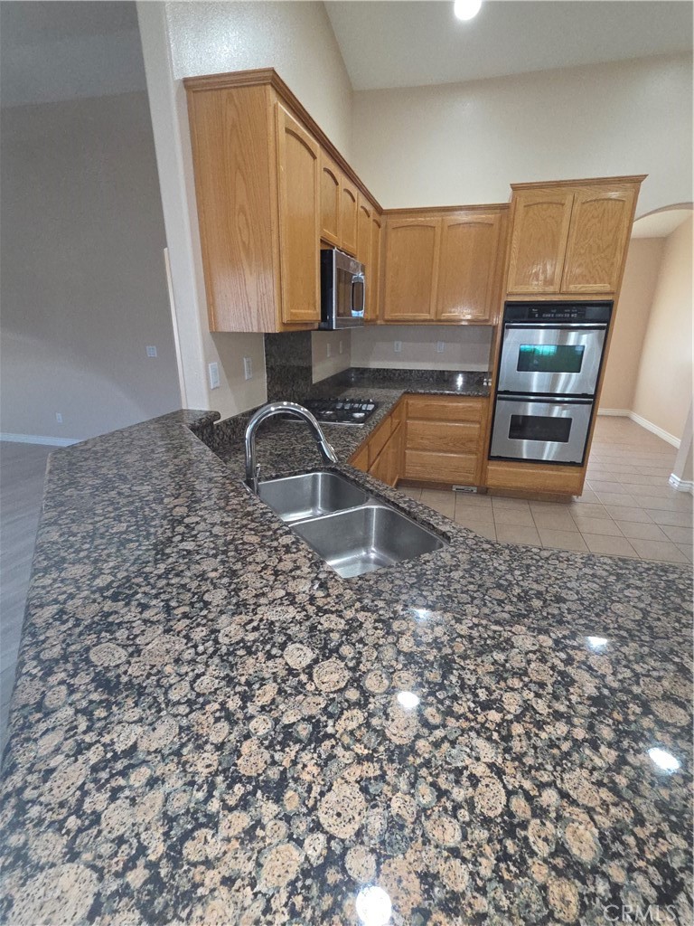 10141 Rochester Road Phelan, CA 92371 - Photo 13 of 22 a kitchen with granite countertop a sink and a stove