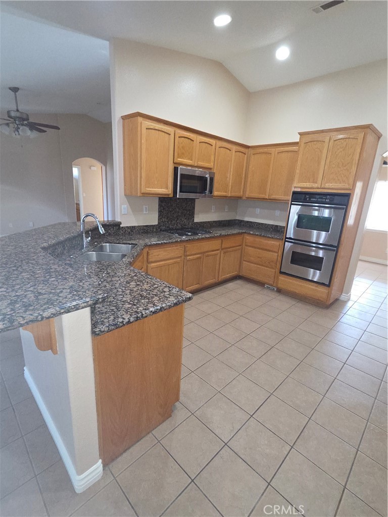 10141 Rochester Road Phelan, CA 92371 - Photo 15 of 22 a kitchen with stainless steel appliances granite countertop a sink and a microwave