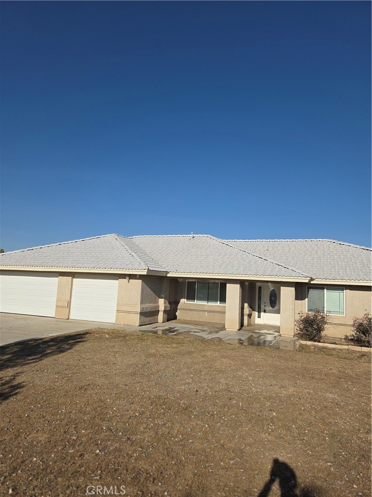 10141 Rochester Road Phelan, CA 92371 - Photo 3 of 22 a front view of a house with a yard