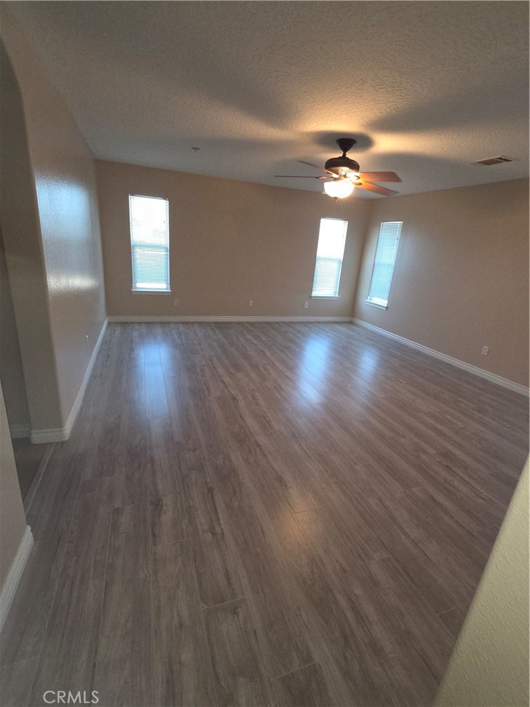 10141 Rochester Road Phelan, CA 92371 - Photo 8 of 22 wooden floor in an empty room with a window