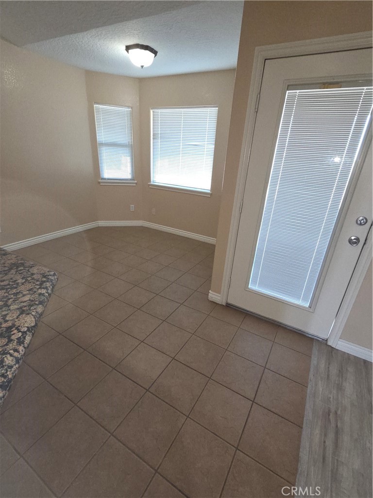 10141 Rochester Road Phelan, CA 92371 - Photo 9 of 22 an empty room with windows