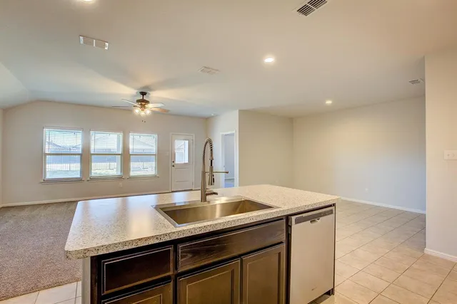 a kitchen with a sink cabinets and window