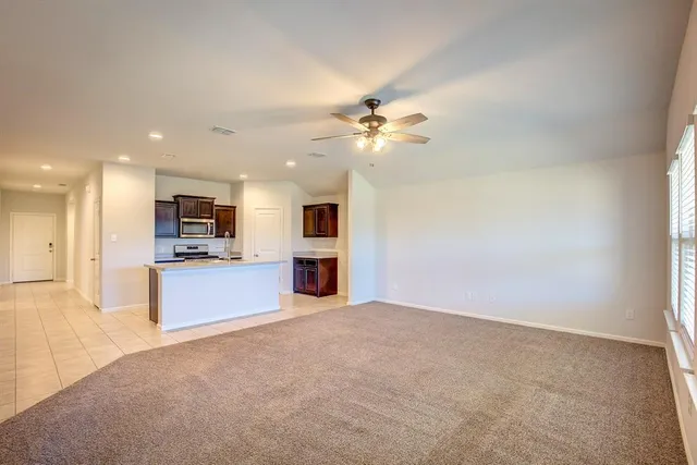 a view of kitchen with refrigerator and a fireplace
