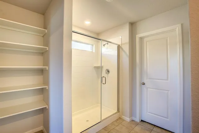 a bathroom with a glass shower door