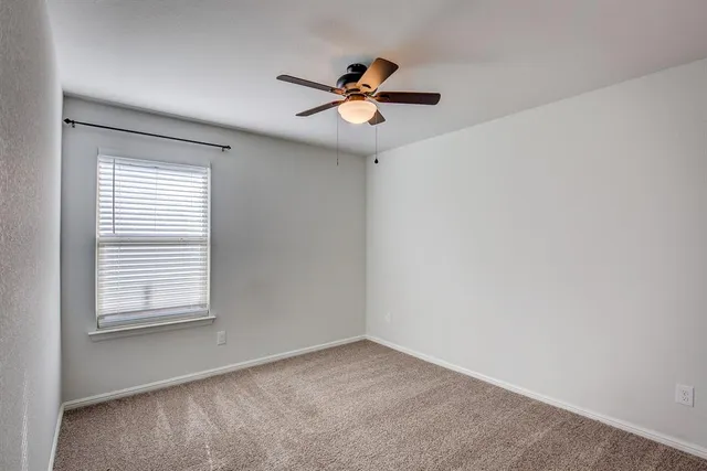 a view of a ceiling fan and a window