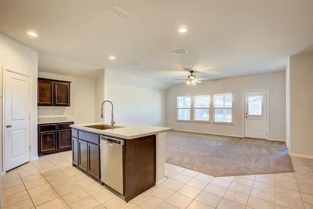 a kitchen with stainless steel appliances granite countertop a stove a sink dishwasher and a refrigerator