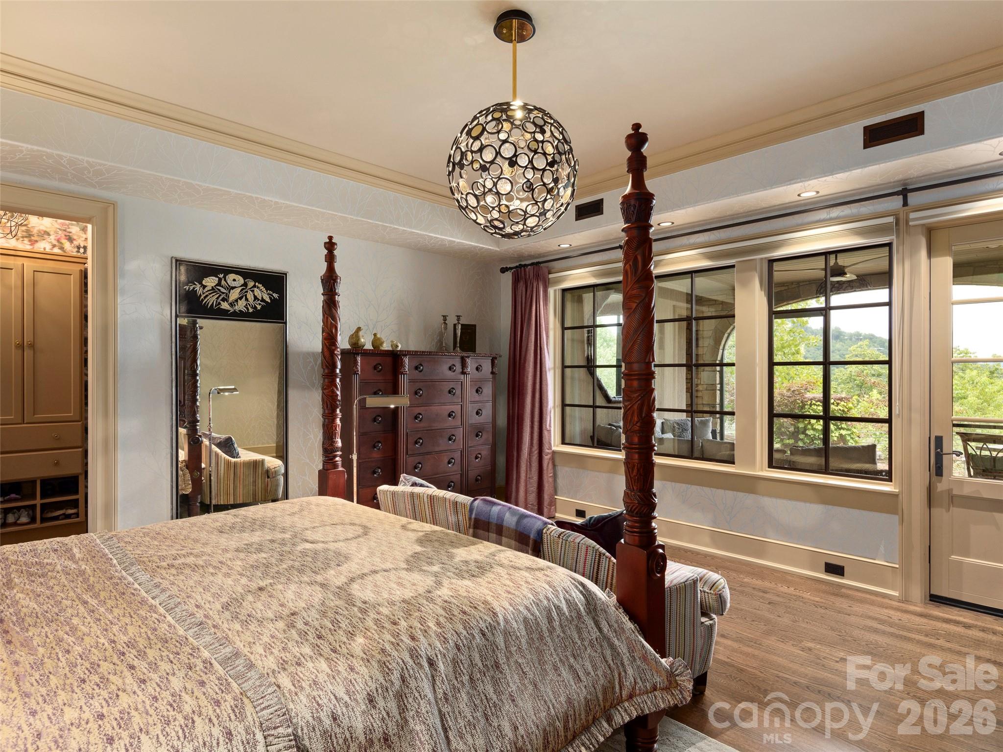 1929 Tree View Trail Arden, NC 28704 - Photo 34 of 48 a bedroom with a bed chandelier and a window