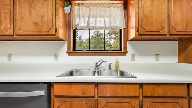 a bedroom with a bed dresser and a window