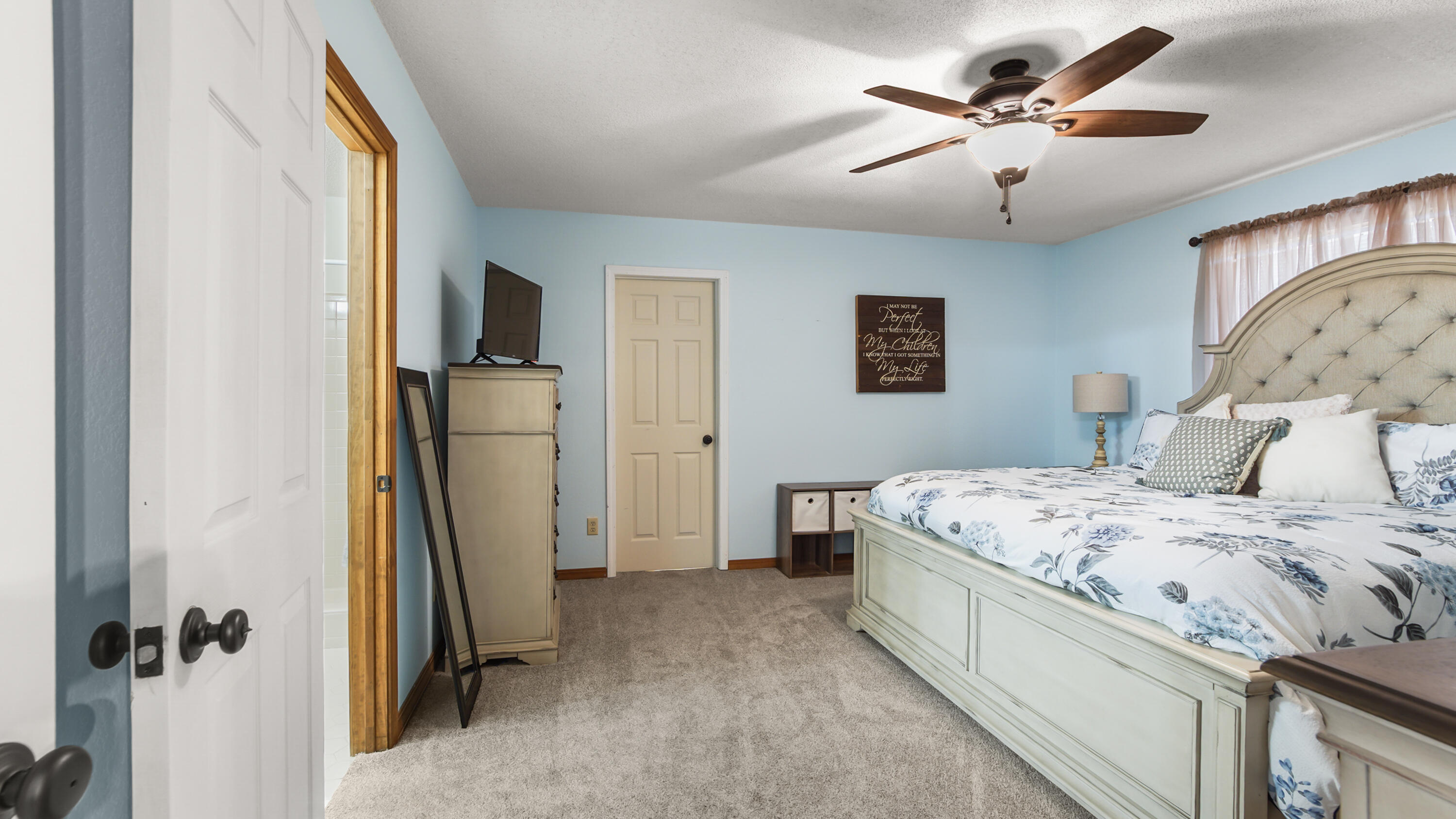 35 Marion Drive DeFuniak Springs, FL 32433 - Photo 13 of 38 a spacious bedroom with a bed and a chandelier