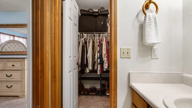a bed sitting in a bedroom next to a window