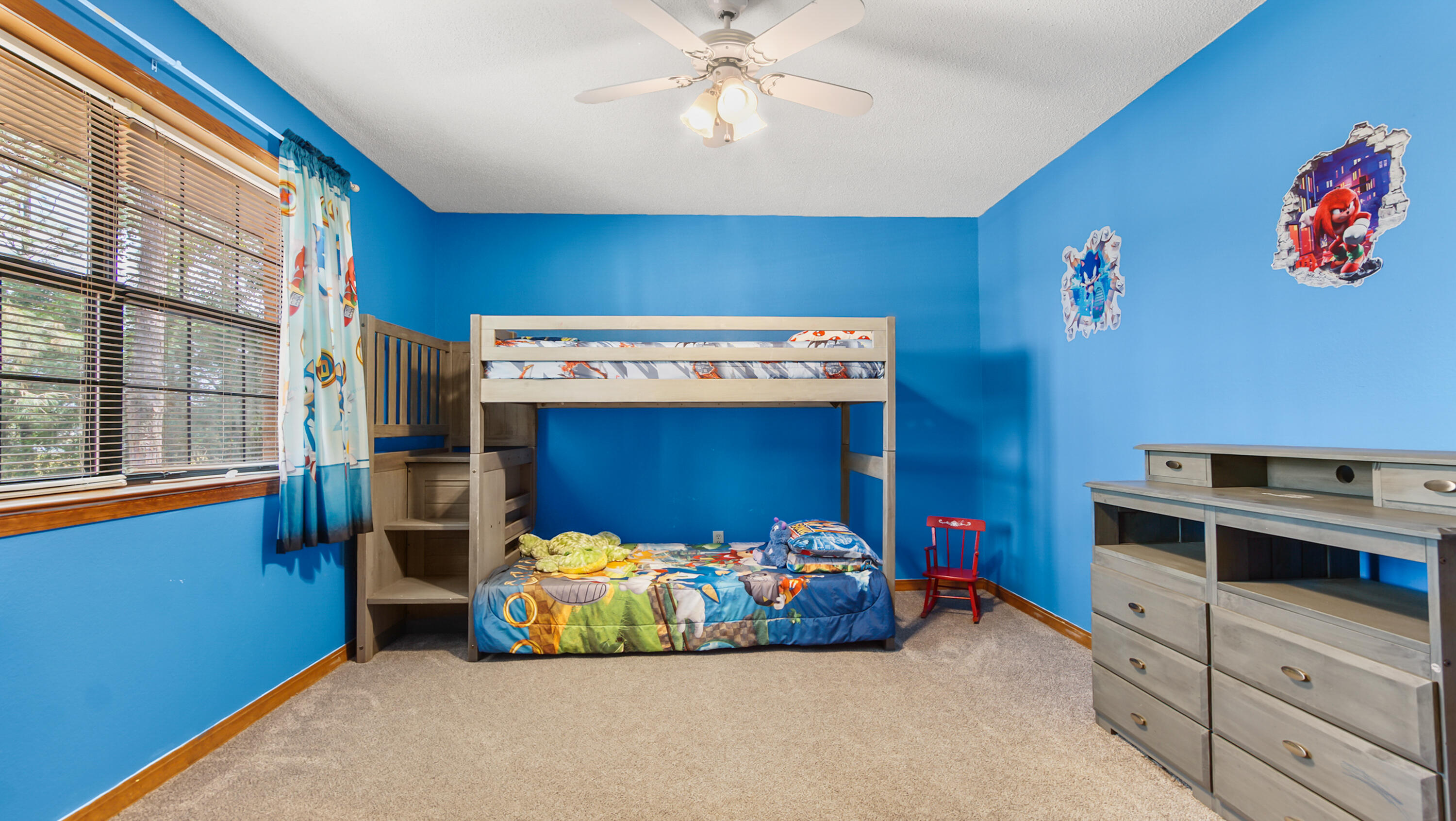 35 Marion Drive DeFuniak Springs, FL 32433 - Photo 20 of 38 a bedroom with furniture and a chandelier