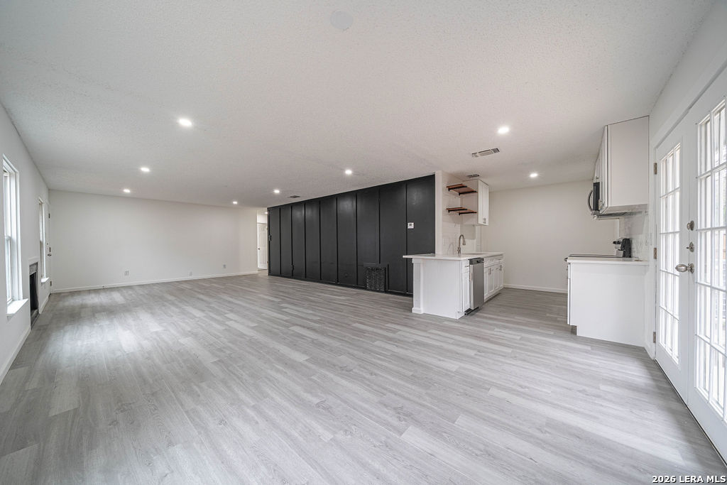 9131 Valley Ridge San Antonio, TX 78250 - Photo 3 of 12 a view of a big room with wooden floor and windows