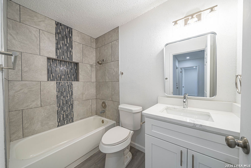 9131 Valley Ridge San Antonio, TX 78250 - Photo 7 of 12 a bathroom with a sink toilet and bathtub