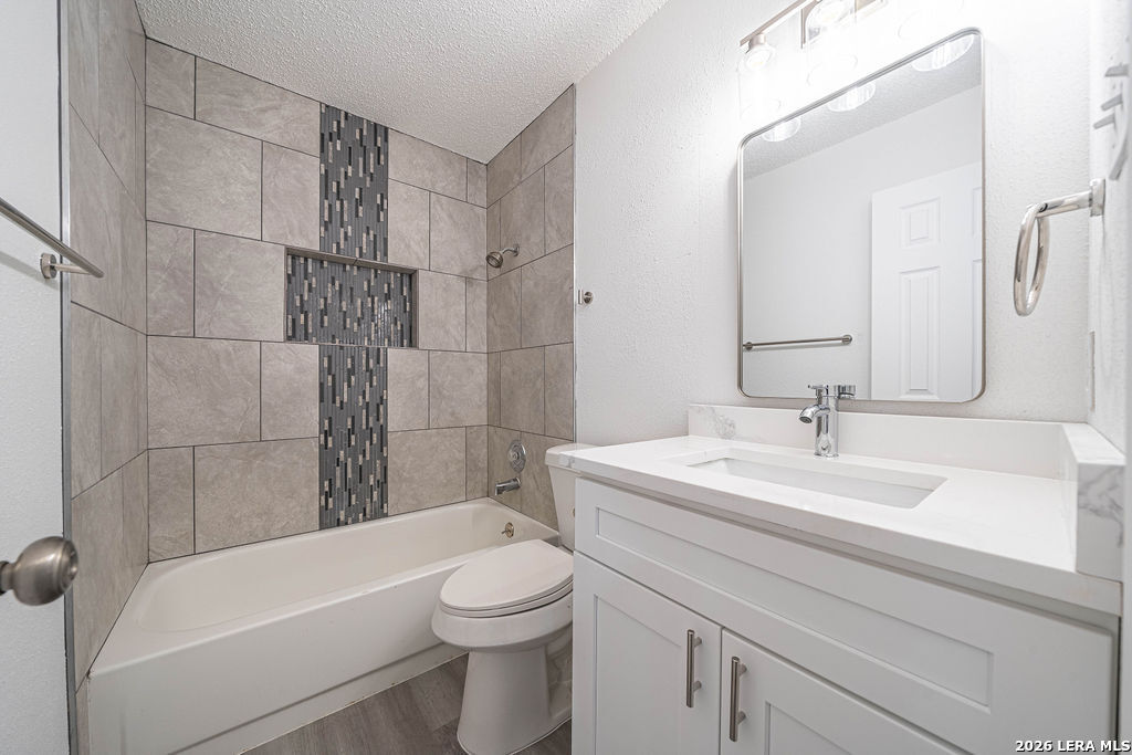 9131 Valley Ridge San Antonio, TX 78250 - Photo 10 of 12 a bathroom with a sink a toilet and shower