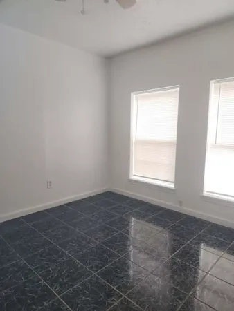 an empty room with a empty space and windows