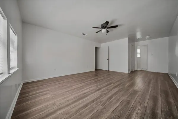 wooden floor in an empty room with a window