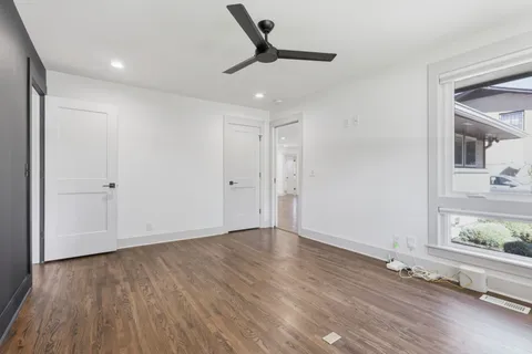 a bed sitting in a bedroom next to a window